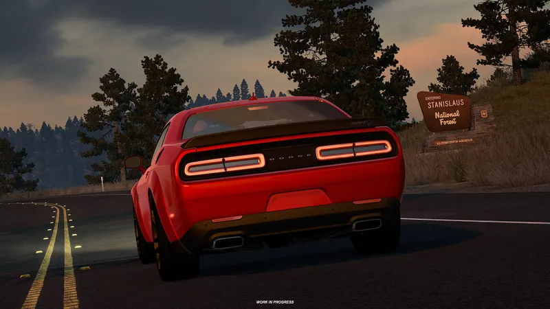 Red Dodge Challenger Hellcat Widebody passing a Stanislaus National Forest sign at dusk in ATS Road Trip
